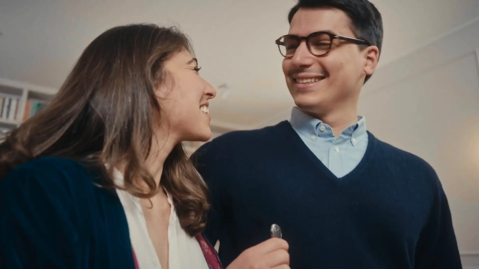 Una coppia sorridente con le chiavi di casa, dallo spot Gnm Immobiliare